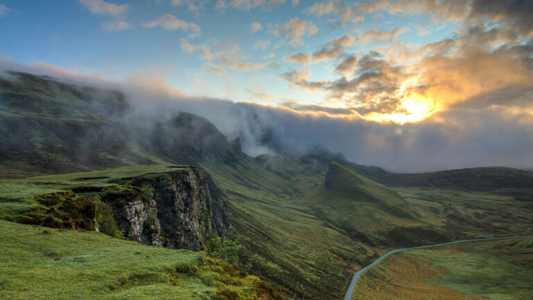 sunset over green mountains