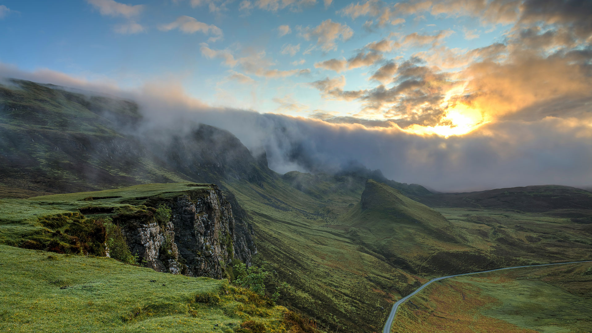 sunset over green mountains